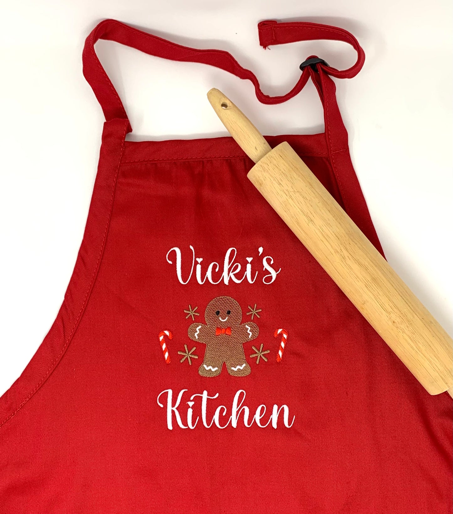 Red, personalized apron with embroidered
gingerbread man.