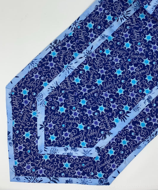 Hanukkah Table Runner quilt featuring stars of David in various shades of blue. measured 15”x49”.